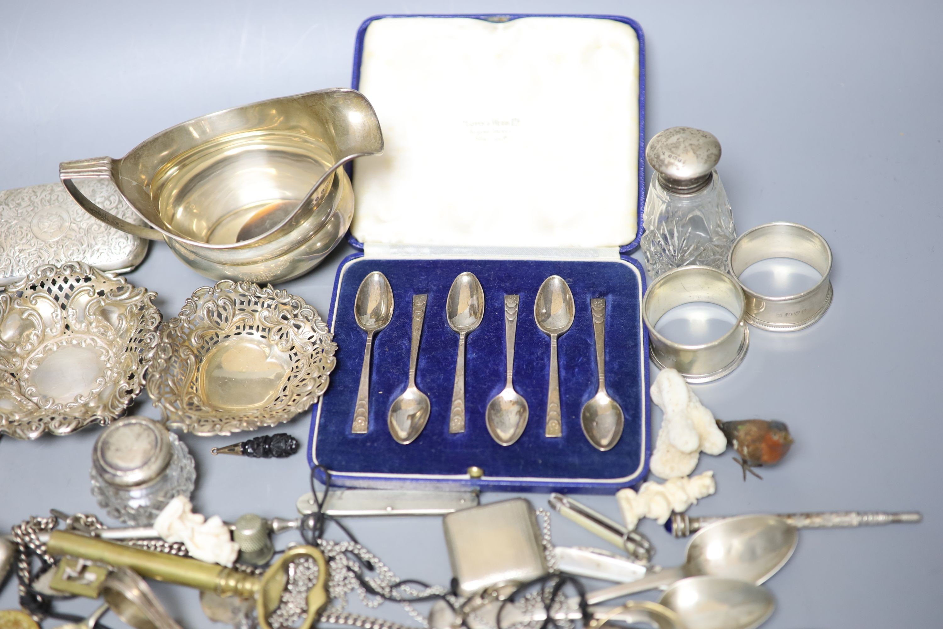 Mixed small silver and other collectable including a cased set of silver silver coffee spoons, a George III silver cream jug, bonbon dishes, cigarette cases, vesta case, flatware, scent bottles, a cold painted bronze bir